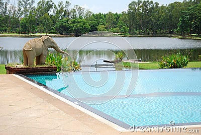 Elephant statuary near swimming pool Stock Photo