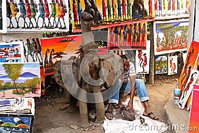 Elephant Statue with Carver and Paintings Editorial Stock Photo