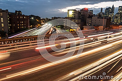 Elevated junction high way asphalt roads with night car traffic lights in the city. Stock Photo