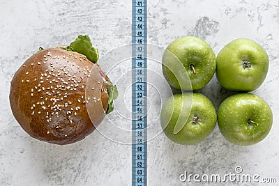 elevated view burger apple compare with measurement tape. High quality photo Stock Photo