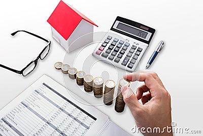 Elevated View Of A Businessperson`s Hand Stacking Coins Stock Photo