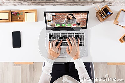 Elevated View Of Businessperson Videoconferencing On Laptop Stock Photo