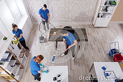 Elevated View Of Janitors Cleaning The Office Stock Photo