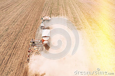 Elevated View Tractor With Seed Drill Machine Sowing Seeds For Crops In Spring Season. Beginning Of Agricultural Spring Stock Photo