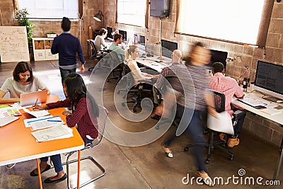 Elevated View Of Workers In Busy Modern Design Office Stock Photo