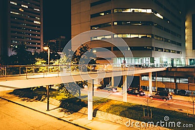 Elevated walkway over Charles Street at night in Baltimore, Mary Stock Photo