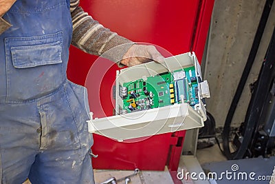 Elevator Technician prepare the elevator control panel for installation Stock Photo