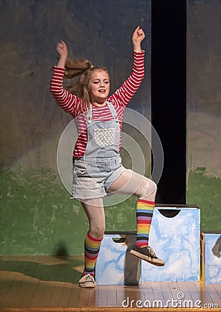 Eleven-year old girl dancing on stage in school play Stock Photo