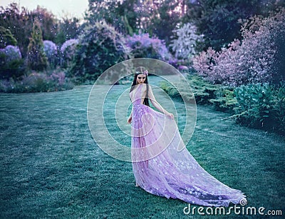 The elf walks in the summer garden. Stock Photo