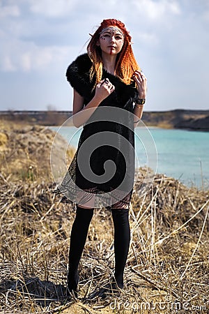 Elf women with fiery hair. Beautiful young fantasy style girl. Stock Photo