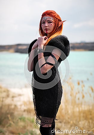 Elf women with fiery hair on nature. Stock Photo