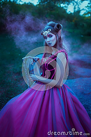 Elf woman in violet dress Stock Photo