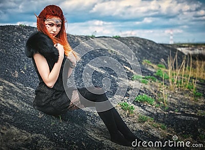 Elf women with fiery hair on nature. Beautiful young fantasy girl. Cosplay character Stock Photo