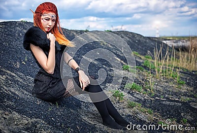 Elf women with fiery hair on nature. Stock Photo