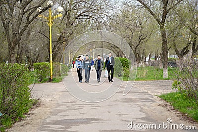 ELISTA, RUSSIA. The group of teenagers - seniors goes along the boulevard of Lenin Street. Kalmykia Editorial Stock Photo