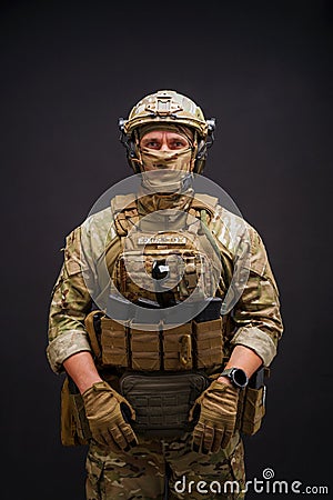 Elit member of Armed Forces of Ukraine man on black background. Soldier man dressed in military ammunition posing on Stock Photo