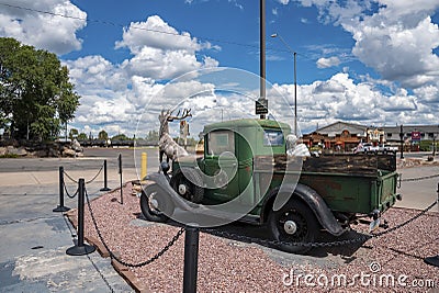 Elk statue and rustic old car at Grand canyon railway junction during summer Editorial Stock Photo
