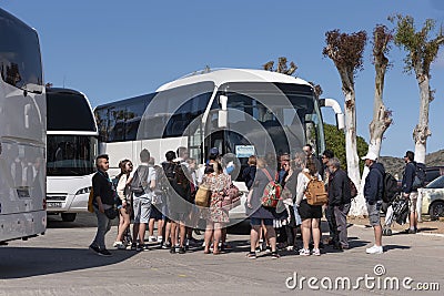 Group of travellers waiting to board their tour bus in Elounda, Crete. Editorial Stock Photo