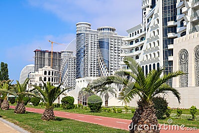 Embankment of Batumi with alley of palm trees, bicycle path and modern architecture Stock Photo