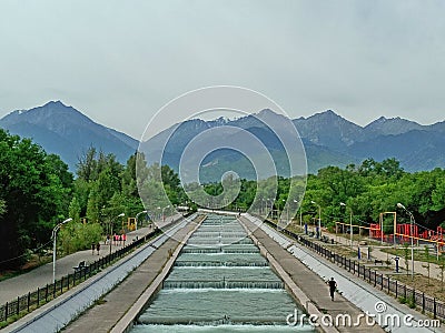 Embankment of the river against the backdrop of mountains. River against the backdrop of mountains. Editorial Stock Photo