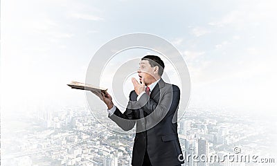 Embarrassed businessman covering mouth with hand Stock Photo