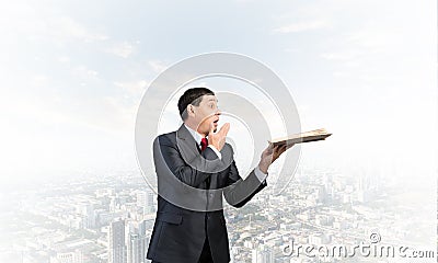Embarrassed businessman covering mouth with hand Stock Photo