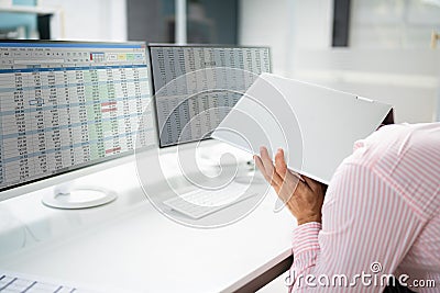 Embarrassed Businessman Hiding Under Laptop Computer Stock Photo