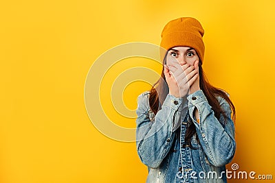Embarrassed emotional astound woman in hat looks with frightened neurotic expression directly at camera Stock Photo