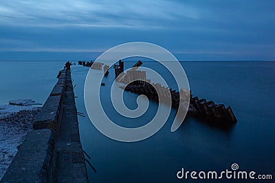 Embedded stones and harbor ruins in Narva-JÃµesuu. Rocky beach, peaceful sea and port. Stock Photo