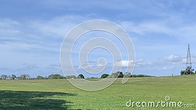 A Symphony of Green Fields, Tower, and Sky Stock Photo