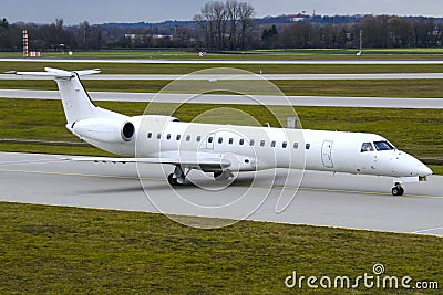 Embraer 145 aircraft on a taxiway Stock Photo