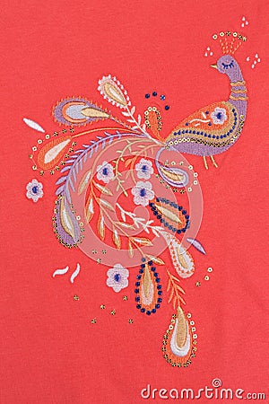 Embroidered bird on red cotton cloth Stock Photo