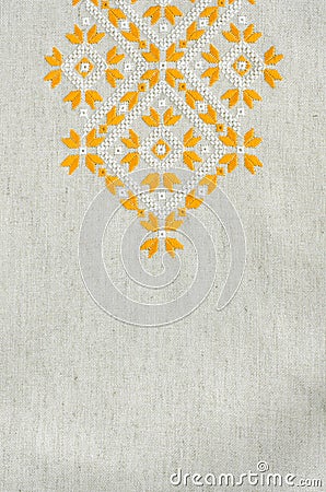 Embroidered fragment on flax by yellow and white cotton threads. Macro embroidery texture flat stitch. Stock Photo