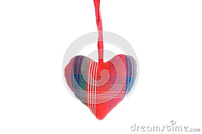 Embroidered heart hanging on a white wall, isolated on white background Stock Photo