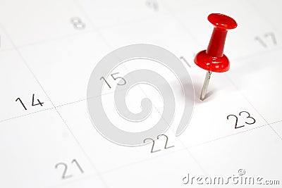 Embroidered red pins on a calendar on the 23rd Stock Photo
