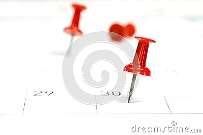 Embroidered red pins on a calendar on the 30th Stock Photo