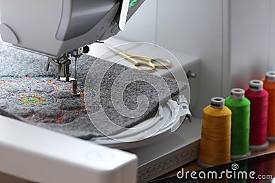 embroidery of colorful mandala on felt with embroidery machine Stock Photo