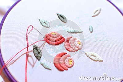 Embroidery with floral motif framed in a hoop. Work in process. Stock Photo