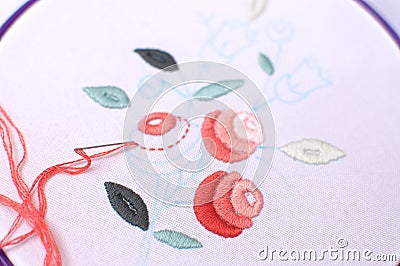 Embroidery with floral motif framed in a hoop. Work in process. Stock Photo