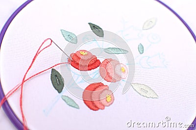 Embroidery with floral motif framed in a hoop. Work in process. Stock Photo