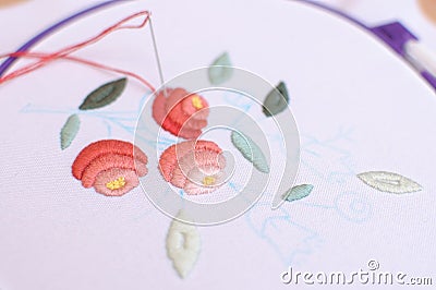 Embroidery with floral motif framed in a hoop. Work in process. Stock Photo