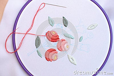 Embroidery with floral motif framed in a hoop. Work in process. Stock Photo