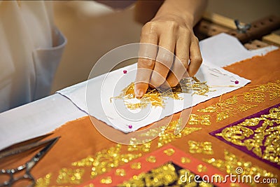 Embroidery a gold lace on fabric. Traditional thai style Stock Photo