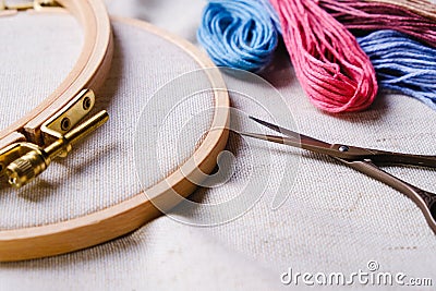Embroidery set. White linen fabric, embroidery hoop, colorful threads and needls. Stock Photo