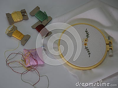 Embroidery stick flower pattern on Fabric handmade DIY sewing accessories have canvas wood hoop and thread put on white background Stock Photo
