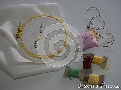 Embroidery stick flower pattern on Fabric handmade DIY sewing accessories have canvas wood hoop and thread put on white background Stock Photo