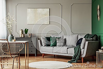 Emerald green and grey living room interior design with abstract painting on the wall Stock Photo