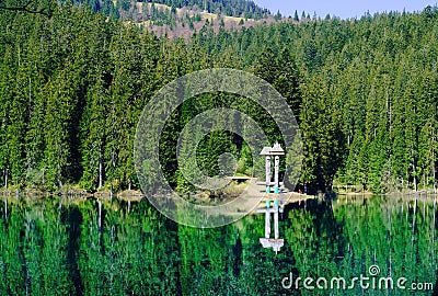 Emerald lake on a background of high mountains and green forest, concept of traveling in the wild, Carpathian, Ukraine, closeup Stock Photo