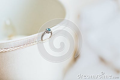 Emerald ring standing on side of textile box Stock Photo