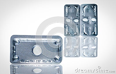 Emergency contraceptive pills in blister pack on blurred background of morning after pills. Drug cause of ectopic pregnancy. Stock Photo